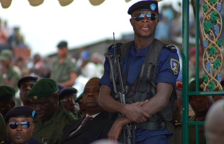 Police guard dignitaries during a military parade in Eastern DRC