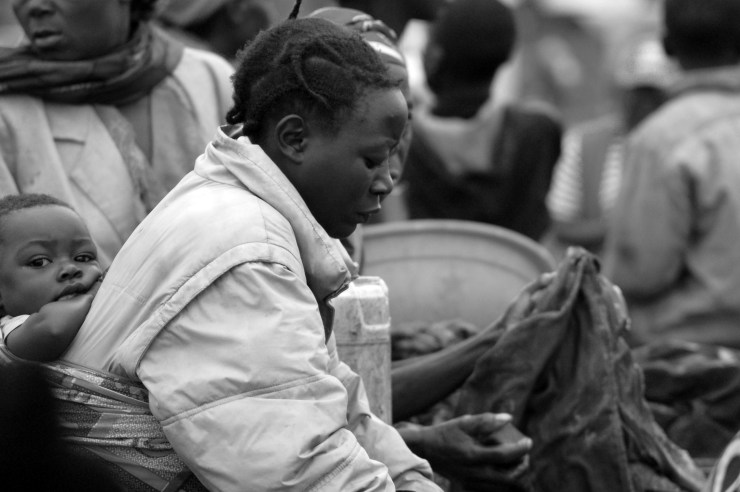 A woman washes clothes in a refugee camp in Eastern DRC