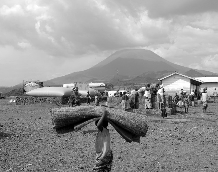 A child carries a bed roll in the KIbati II refugee camp outside Goma in the Eastern DRC